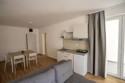 a living room with a couch and a table and a kitchen at Milutinn-Visterija in Soko Banja