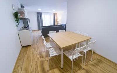 a dining room table and chairs in a living room at Milutinn-Visterija in Soko Banja