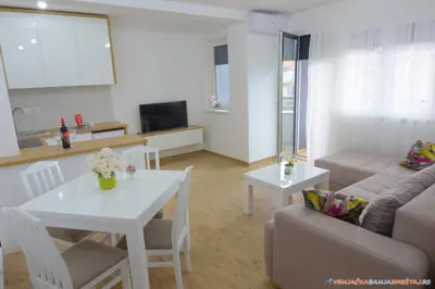 a living room with a couch and a table at Neda Lux Apartmani 5 nocenja, šesto gratis in Vrnjačka Banja