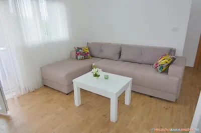 a living room with a couch and a table at Neda Lux Apartmani 5 nocenja, šesto gratis in Vrnjačka Banja
