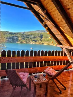 a view of a lake from the porch of a cabin at Zavojsko jezero - Vila Jezero in Pirot