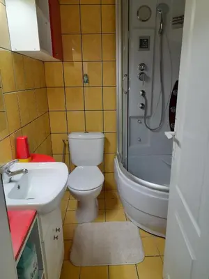 a bathroom with a toilet and a sink and a shower at Family Apartman in Jagodina