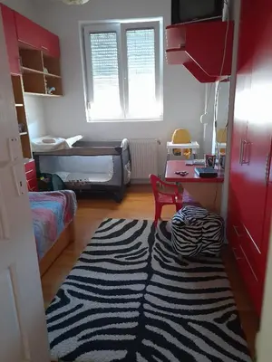 a room with a zebra rug in a room with a bedroom at Family Apartman in Jagodina