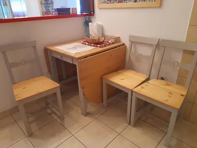a small table and two chairs in a room at Family Apartman in Jagodina