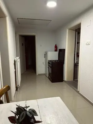a living room with a refrigerator and a table at Privatni smestaj - Grujic in Bujanovac