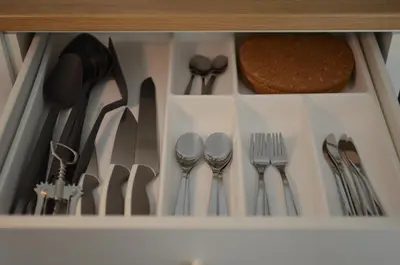 a drawer filled with silver utensils at TIKE, TAK - Central Residence in Niš