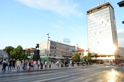 a group of people crossing a street in a city at TIKE, TAK - Central Residence in Niš