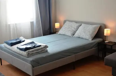 a bedroom with a bed with towels on it at TIKE, TAK - Central Residence in Niš