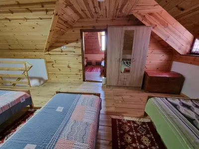 a room with two beds in a log cabin at Country House Sunčev breg in Bara Slatina