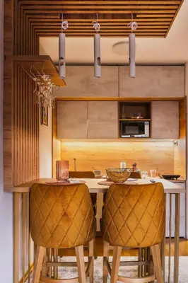 a kitchen with a table and two chairs at Apartman 'Kapljica' in Vrnjačka Banja