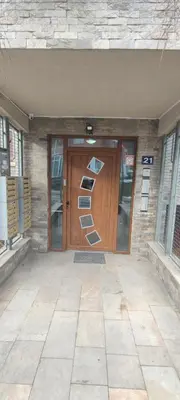 a front door of a building with a sign on it at Apartman 'Kapljica' in Vrnjačka Banja