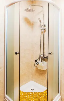 a shower with a glass door in a bathroom at Apartman 'Kapljica' in Vrnjačka Banja