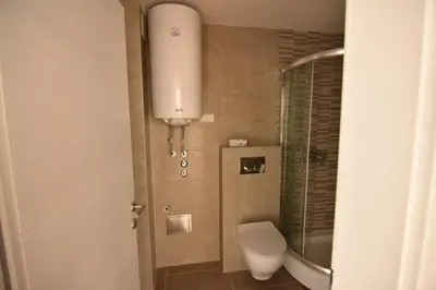 a small bathroom with a toilet and a shower at Apartman Lipa 11 in Vrnjačka Banja