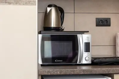 a microwave on a counter with a kettle on top of it at Milmari K13 in Kopaonik