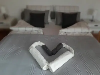 a heart made out of towels on a bed at Apartman Ljiljan in Niš