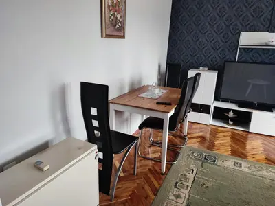 a kitchen with a table and chairs and a television at MilijicLux in Soko Banja