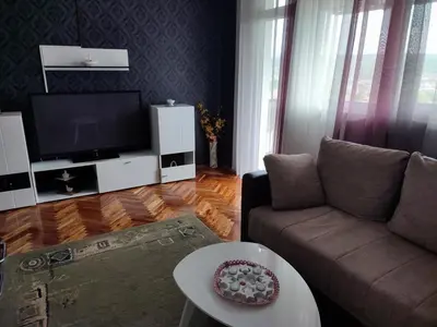 a living room with a couch and a tv at MilijicLux in Soko Banja