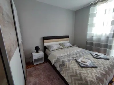 a small bedroom with a bed and a window at MilijicLux in Soko Banja
