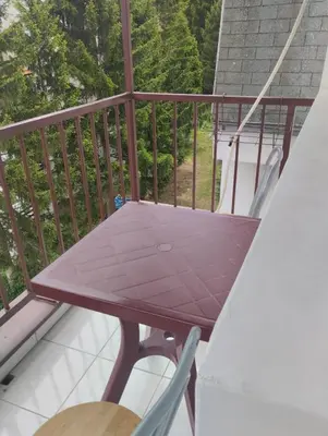 a balcony with a purple table and chairs at MilijicLux in Soko Banja