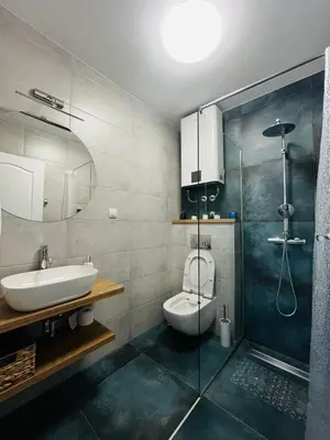a bathroom with a toilet and a sink and a shower at Studio apartman MarMar in Vrnjačka Banja