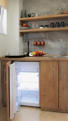 a kitchen with an open dishwasher in a kitchen at Studio apartman MarMar in Vrnjačka Banja