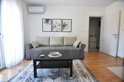 a living room with a couch and a coffee table at Apartman Point in Vrnjačka Banja
