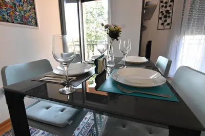 a black dining room table with chairs and glasses at Apartman Point in Vrnjačka Banja