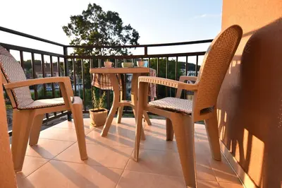 a patio with two chairs and a table on a balcony at Apartman Point in Vrnjačka Banja