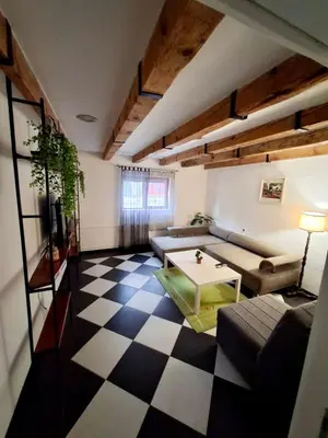 a living room with a couch and a table at Downtown apartment in Niš