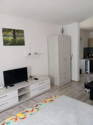 a living room with a flat screen tv on a cabinet at Apartmani Nana in Vrnjačka Banja