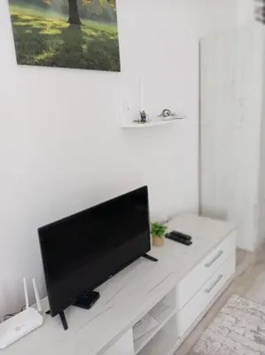 a flat screen tv sitting on top of a white entertainment center at Apartmani Nana in Vrnjačka Banja