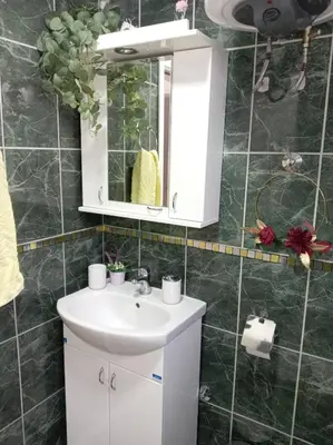 a bathroom with a white sink and a mirror at Apartmani Nana in Vrnjačka Banja