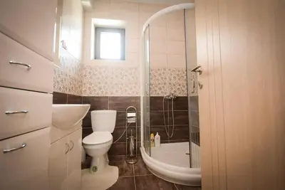 a bathroom with a toilet and a shower and a sink at Panorama LUX in Vrnjačka Banja