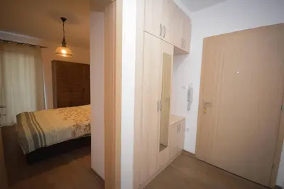 a room with a bedroom with a bed and a closet at Panorama LUX in Vrnjačka Banja