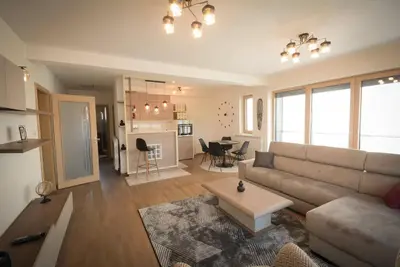 a living room with a couch and a table at Panorama LUX in Vrnjačka Banja