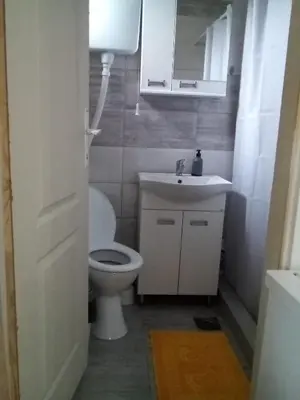 a bathroom with a toilet and a sink and a mirror at Konak Jerma-Kanjon Jerme Pirot in Pirot