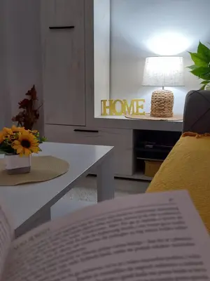 a living room with a couch and a table with a book at Konak Jerma-Kanjon Jerme Pirot in Pirot