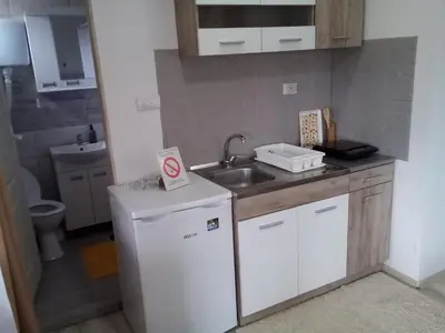 a small kitchen with a sink and a refrigerator at Konak Jerma-Kanjon Jerme Pirot in Pirot