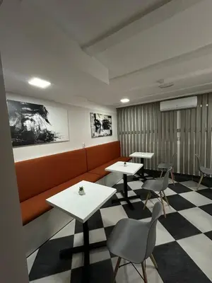 a waiting room with two tables and chairs at Vila Storia in Niš
