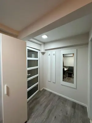 an empty room with white walls and a mirror at Vila Storia in Niš