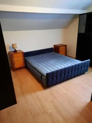 a large blue bed in a room with a wooden floor at Ferienwohnung Süß in Kovanluk