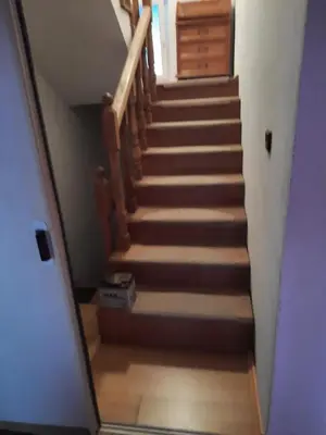 a stairway leading up to a room with a wooden staircase at Ferienwohnung Süß in Kovanluk