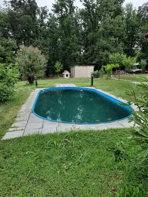a swimming pool in a yard with a grass field at Ferienwohnung Süß in Kovanluk