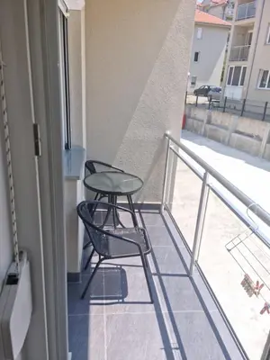 a balcony with two chairs and a table at Apartman Miloš in Soko Banja