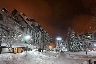 a city street covered in snow at night at NevSki Apartments in Kopaonik