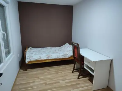 a small bedroom with a desk and a bed at Sweet home B in Niš