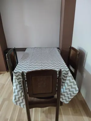 a small table with a table cloth on it with a chair at Sweet home B in Niš