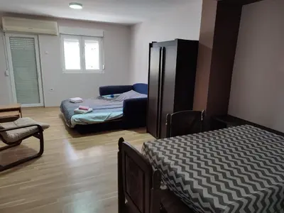 a room with two beds and a couch in it at Sweet home B in Niš
