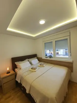 a bedroom with a large bed and a window at Verona 25 in Vrnjačka Banja