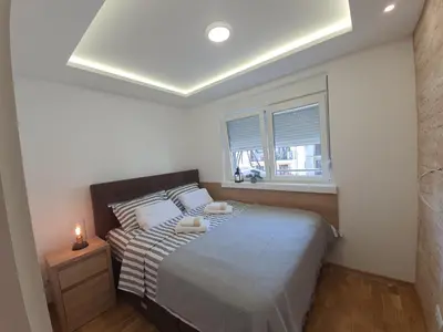 a bedroom with a bed and a window at Verona 25 in Vrnjačka Banja